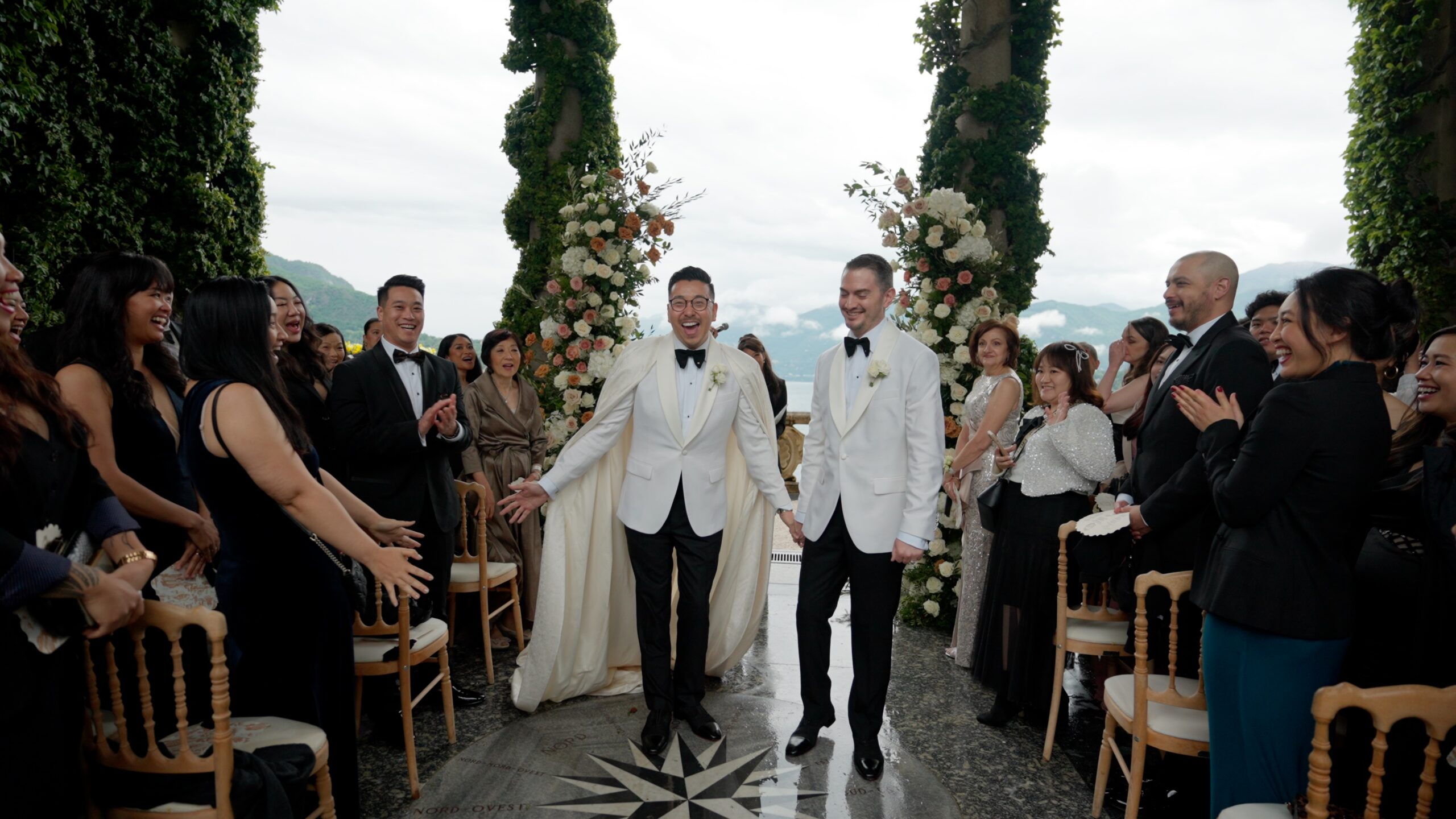 Groom and groom exiting Villa del Balbianello ceremony at Lake Como